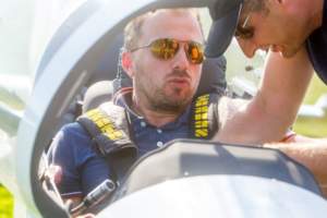 A pilot in a formula one racing aircraft preparing for takeoff.