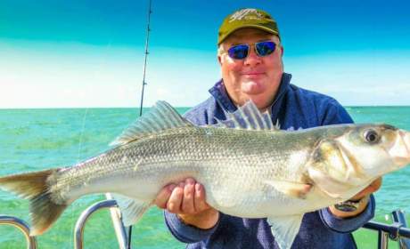 Peter out fishing wearing his Bigatmo polarized sunglasses, holding the catch of the day.