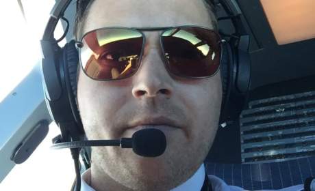 Commercial airline pilot wearing Bigatmo sunglasses sitting in the flightdeck of an airbus