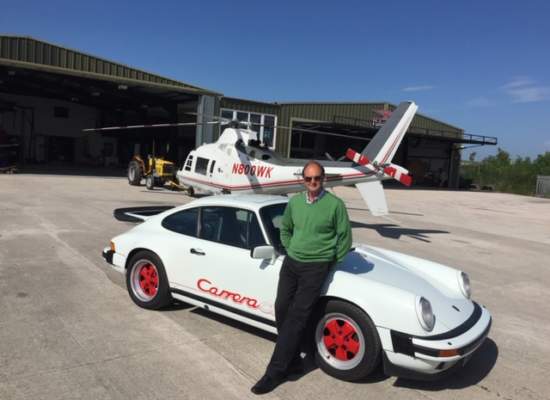 man leaning on his white Porche Carrera wearing Bigatmo sunglasses