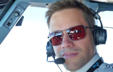 Commercial pilot wearing Bigatmo Iono photochromic sunglasses with ANR headset
