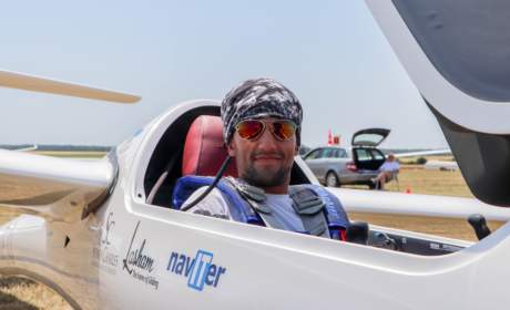 Jake Brattle wearing Bigatmo sunglasses and sitting in his glider before racing in France.